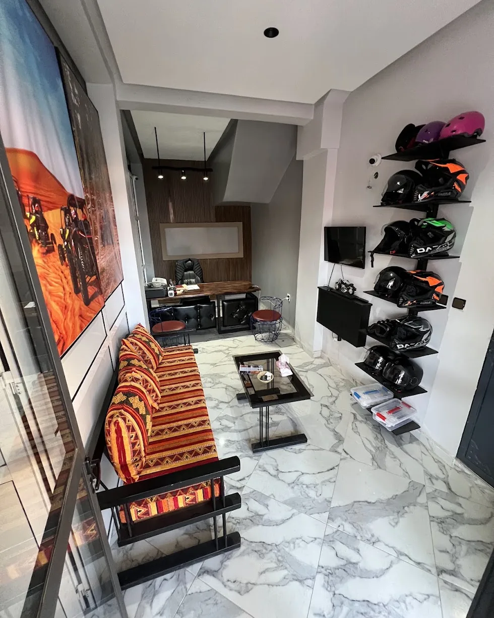 Inside the GoSahara Quad office, with seating, reception desk and helmets on shelves